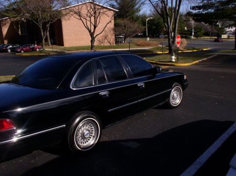 1997 Ford Crown Victoria - This black 1997 Ford Crown Victoria sedan is captured from a 3/4 front angle, its classic body style.