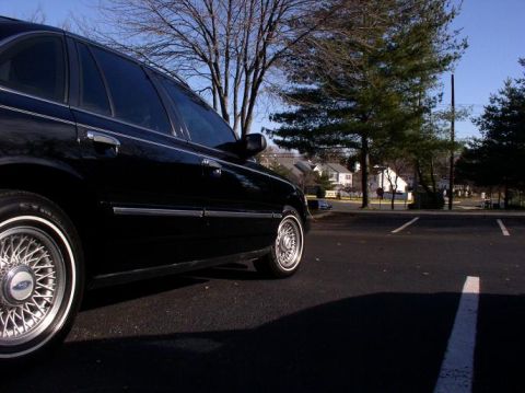 1997 Ford Crown Victoria - Black 1997 Ford Crown Victoria parked in an outdoor lot on a sunny day.