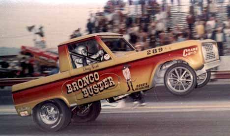 1988 Ford Bronco - Drag racing truck with "Bronco Buster" graphics, front wheels off the ground at a drag strip.