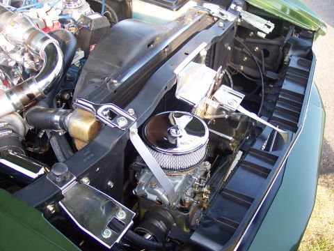 1973 Ford Mustang - Customized engine bay features a prominent air cleaner and polished components.