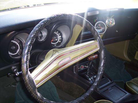 1973 Ford Mustang - The interior of a 1973 Ford Mustang, a custom steering wheel cover and distinctive dash accents.