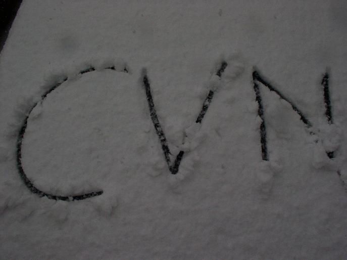 CVN written in snow on a surface, with Supermotors.net watermark at bottom right