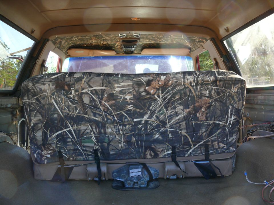 Rear seat with camouflage cover and visible SuperMotors logo