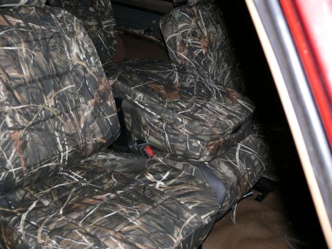 1988 Ford Bronco - Vehicle interior with camouflage seat covers installed on the front seats.