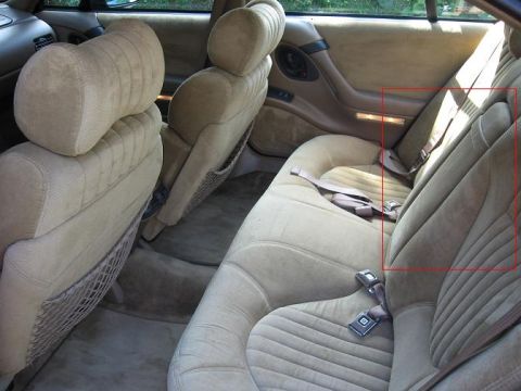 1992 Ford Crown Victoria - The interior of a car, focusing on the rear seats and door panel. A red box highlights a specific area.