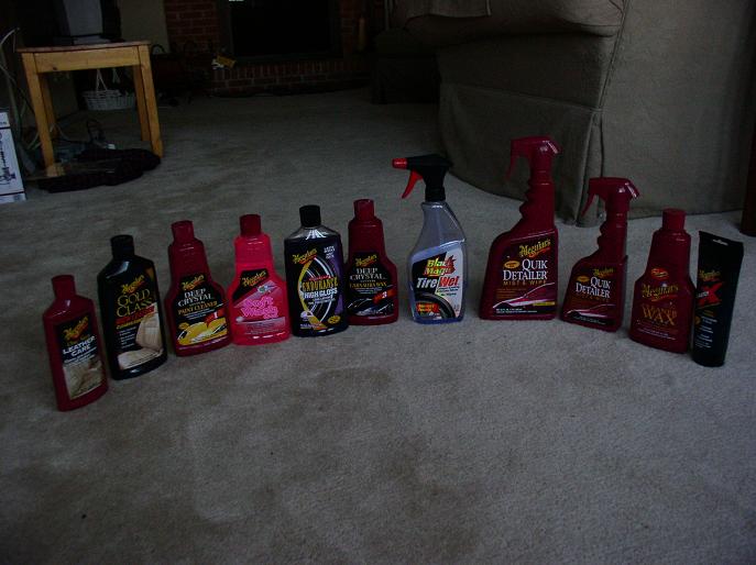 Row of Meguiar's car cleaning bottles and tubes on a carpeted floor