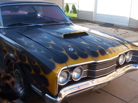 1971 Mercury Cyclone - Front view of a 1969 Mercury Cyclone flame graphics and a hood scoop.
