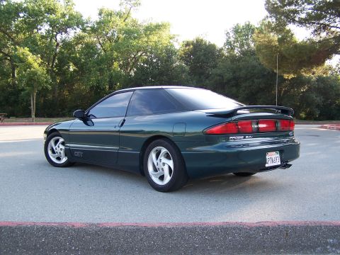 1996 Ford Probe - Rear view of a 1996 Ford Probe GT coupe. The car is dark green with a spoiler and aftermarket wheels.