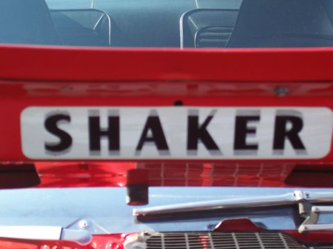 1973 Ford Mustang - A close-up view of a red car's rear decklid displays a "SHAKER" badge.
