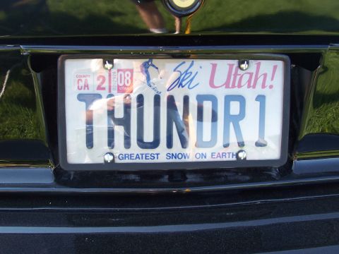 1973 Ford Mustang - A license plate on a black vehicle displays "THUNDR1" with "Ski Utah!" and "Greatest Snow on Earth" text.