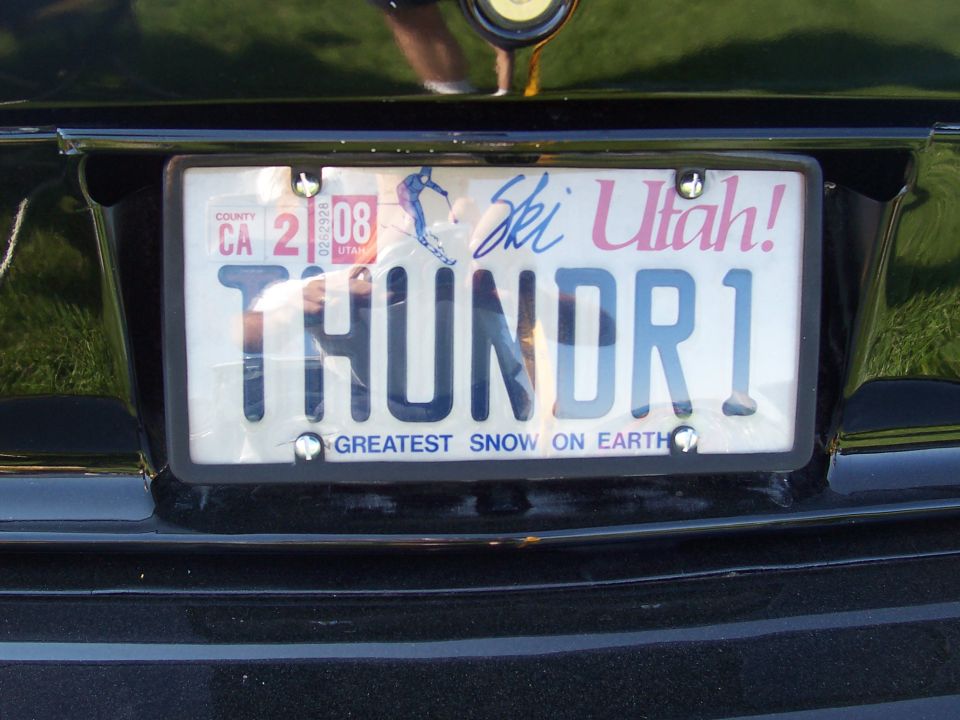 Black car rear bumper with a California license plate reading THUNDR1 and a "Ski Utah!" graphic