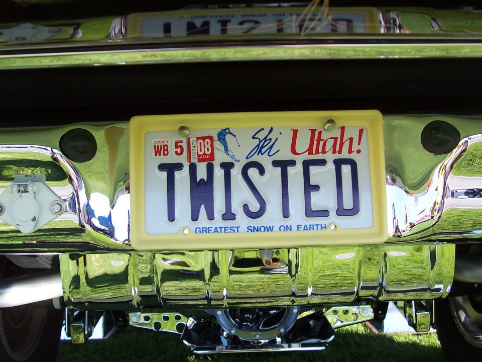 Rear bumper with chrome trim and a yellow license plate frame holding a "TWISTED" Ski Utah plate