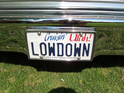 1973 Ford Mustang - License plate reads 'LOWDOWN' with 'Cruisin' Utah!' above it. The frame says 'OLDIE & HOT RODS FOREVER'.
