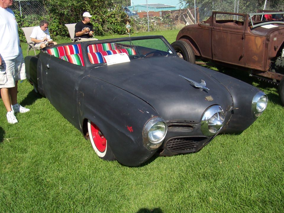 Black convertible with striped interior and red wheels