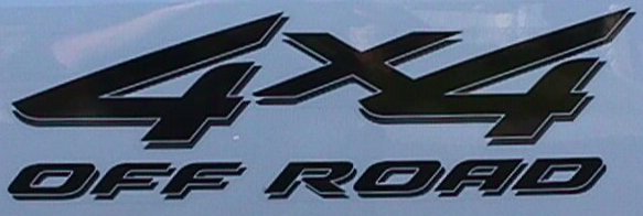 Close-up of black '4x4 Off Road' decal on light blue painted body panel