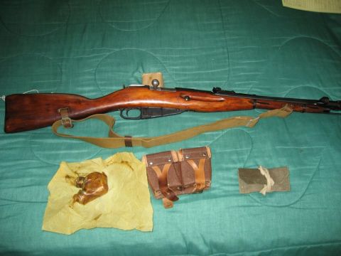 2004 Ford F-150 - A rifle and its accessories are laid out on a green fabric surface.