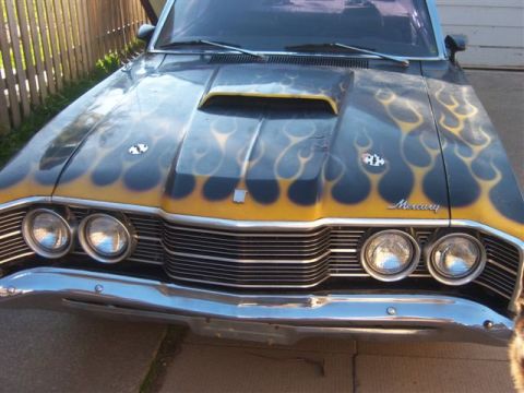 1971 Mercury Cyclone - Front view of a black car with flame graphics and a hood scoop.