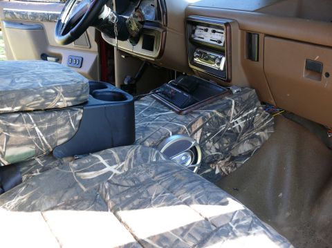 1988 Ford Bronco - The interior of this 1988 Ford Bronco features camouflage seat covers and an aftermarket stereo system.