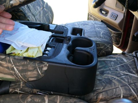 1988 Ford Bronco - Camouflage seat covers over vehicle interior, showing center console and storage.