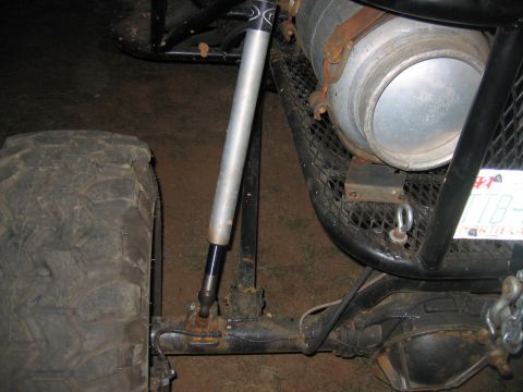 1992 Ford Mustang - Close-up of off-road vehicle suspension components and a large auxiliary fuel tank.