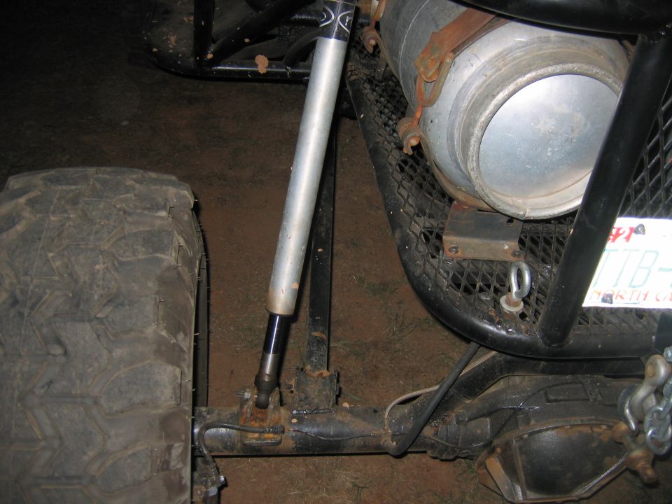 Off-road vehicle rear axle, shock absorber, and large fuel tank mounted on a roll cage