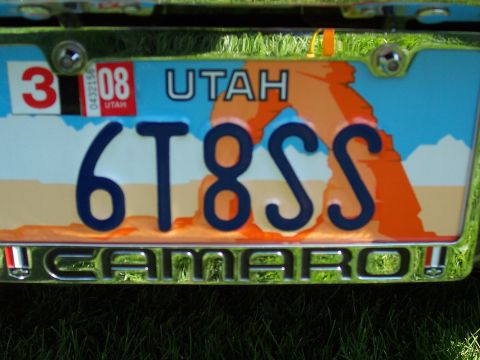 1973 Ford Mustang - License plate reads 6T8SS, with a Camaro emblem visible on the vehicle.