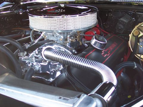1973 Ford Mustang - Close-up of an engine bay a chrome air cleaner and Chevrolet valve covers.