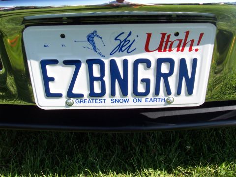 1973 Ford Mustang - A Utah license plate reading EZBNGRN is mounted on a vehicle's rear bumper.