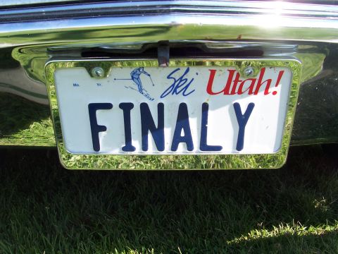 1973 Ford Mustang - The rear of a vehicle displays a Utah license plate with the custom text FINALLY and a graphic of a skier.