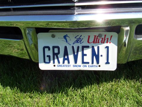 1973 Ford Mustang - A close-up view of a vehicle's front bumper and license plate, with grass in the foreground.