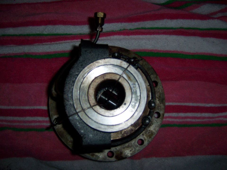 Close-up of a vehicle part with ball bearings and a bolt