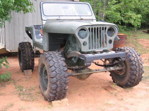 1980 Jeep CJ7 - Jeep CJ body undergoing restoration, showing its distinctive grille and large tires.