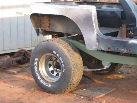 1980 Jeep CJ7 - This Jeep CJ body is undergoing repairs, with visible rust and missing body panels.