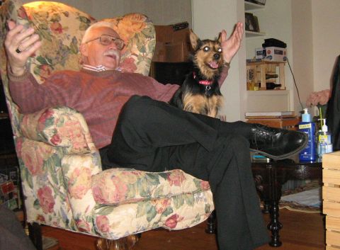 1988 Mercury Grand Marquis - A man and his dog relax in an armchair in a living room setting.