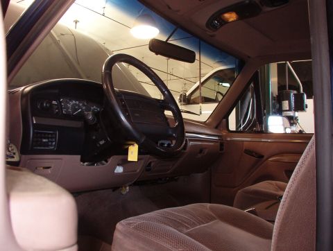 1983 Ford Bronco - The interior of a 1992 Ford Bronco, with a second vehicle visible outside.