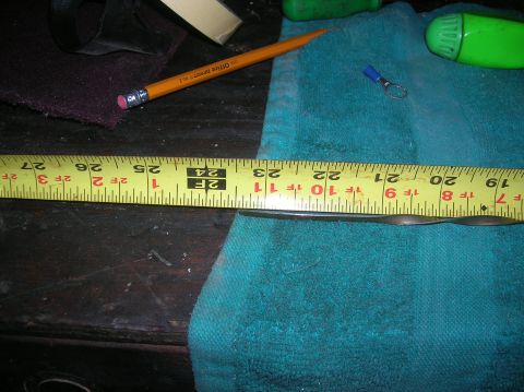 1985 Ford Bronco - A close-up view of a measuring tape, pencil, and wire connector on a teal cloth surface.
