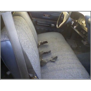1973 Ford Ranchero - The interior of a vehicle is shown, a bench seat and dashboard details.