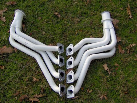1978 Ford Bronco - White exhaust headers are shown on a grassy surface.