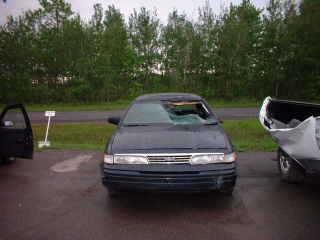 1996 Ford Crown Victoria front view with broken windshield and open driver door
