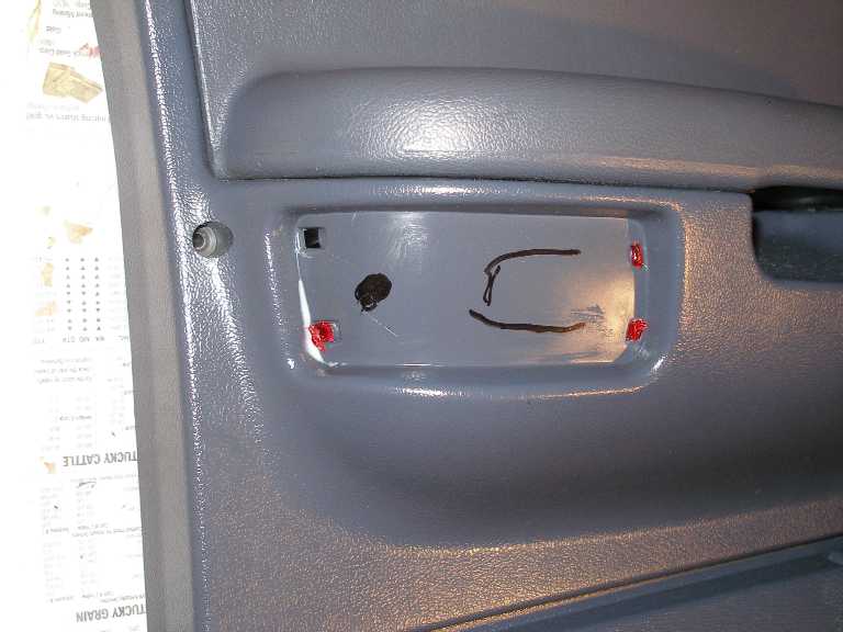 Place the soon-to-be installed lense and bulb housing over the panel and mark where to cut.