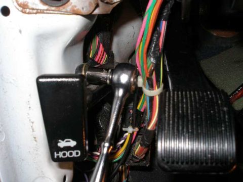 2001 Ford Crown Victoria - To run the coathanger into the interior, it is best to move the hood relase out of the way.