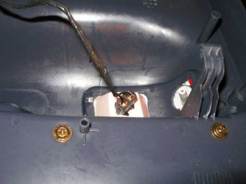 2001 Ford Crown Victoria - Close-up of interior door panel wiring and a light socket, likely for a courtesy lamp.
