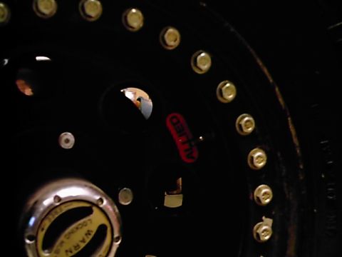 1995 Ford Bronco - A close-up view of a vehicle's wheel hub assembly, a Warn locking hub and Allied branding.