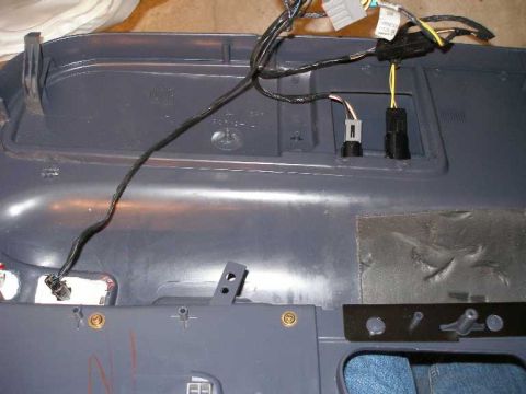2001 Ford Crown Victoria - Reinstalling the driver's door. Note the two harnesses and connectors for the fuel and trunk release buttons.