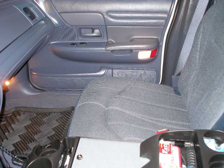 Gray interior passenger side door panel and cloth seat of a car