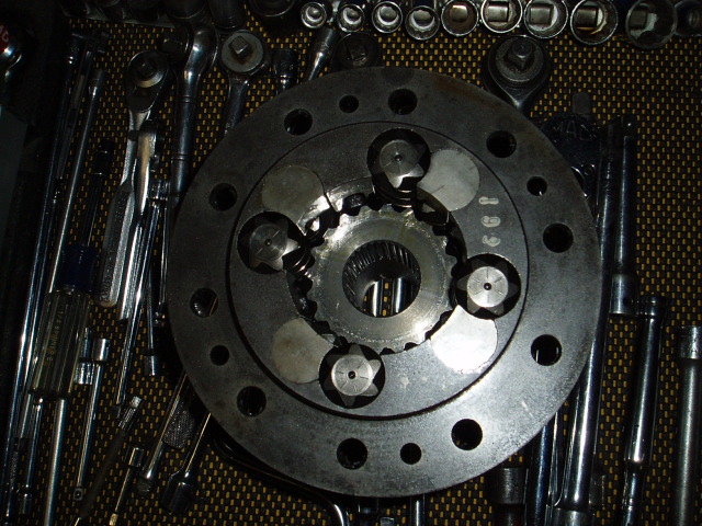 Close-up of a locking differential part with various tools laid out around it