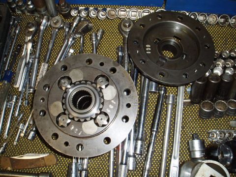 1980 Ford Bronco - Differential components and a collection of mechanic's tools laid out on a textured surface.