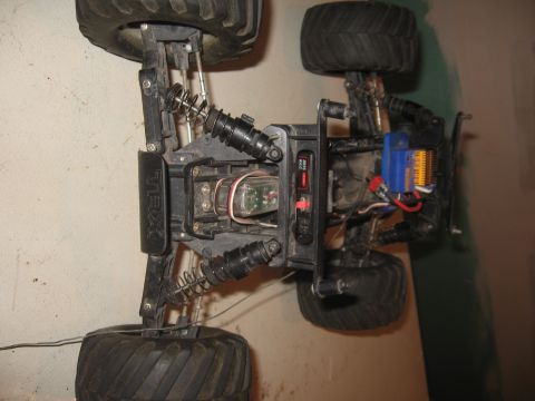 1979 Ford Bronco - Underside view of a remote control monster truck chassis, showing its complex suspension and electronic components.