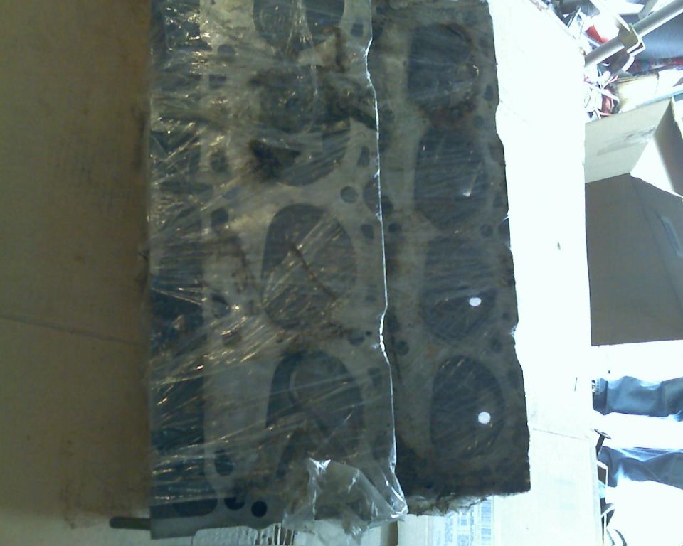 Two engine cylinder heads wrapped in plastic