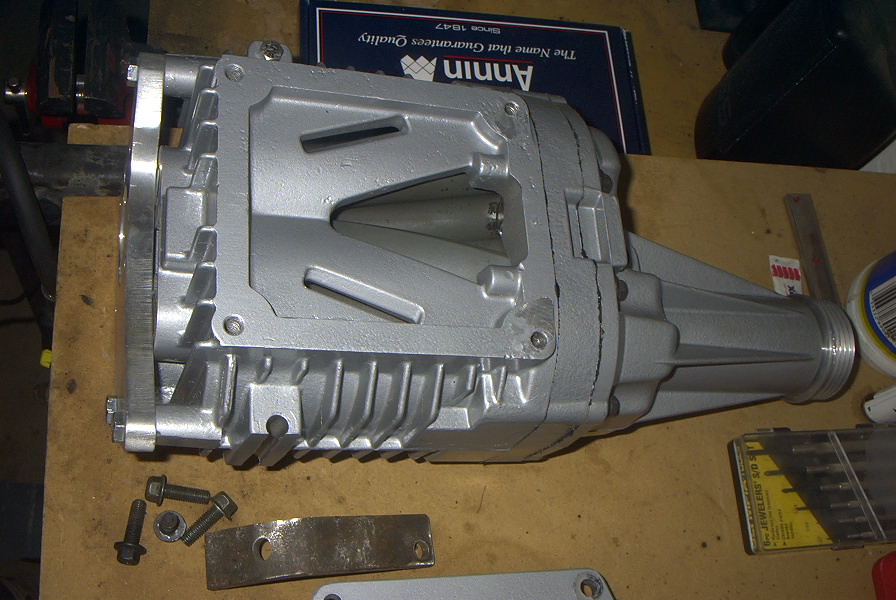 Silver supercharger with fins and mounting bolts